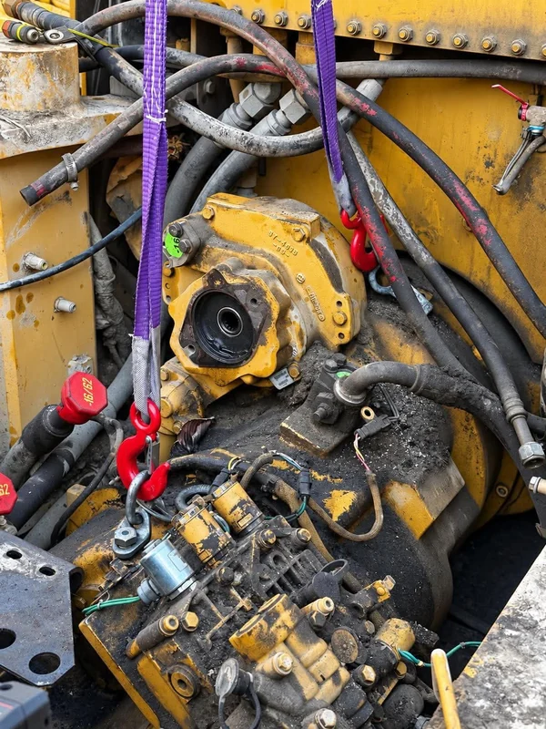 Pump and valve assembly on heavy equipment, opened up for service